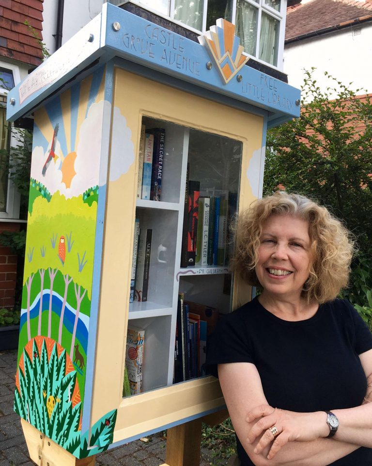 Teresa Flavin with the Free Little Library she painted in 2021 Teresa Flavin with the Free Little Library she painted in 2021